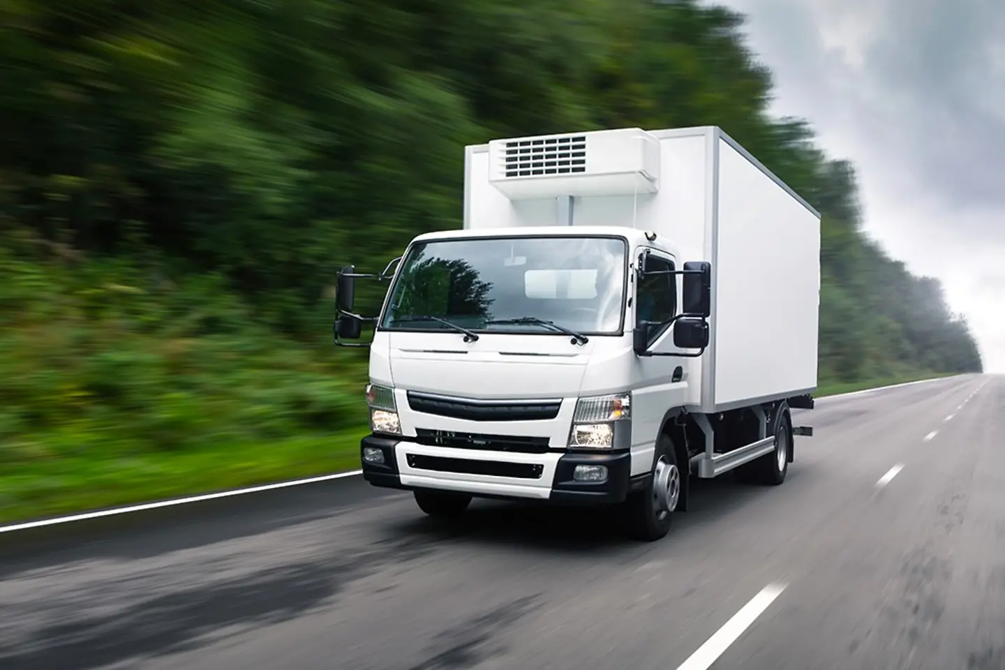 White truck driving on a country road