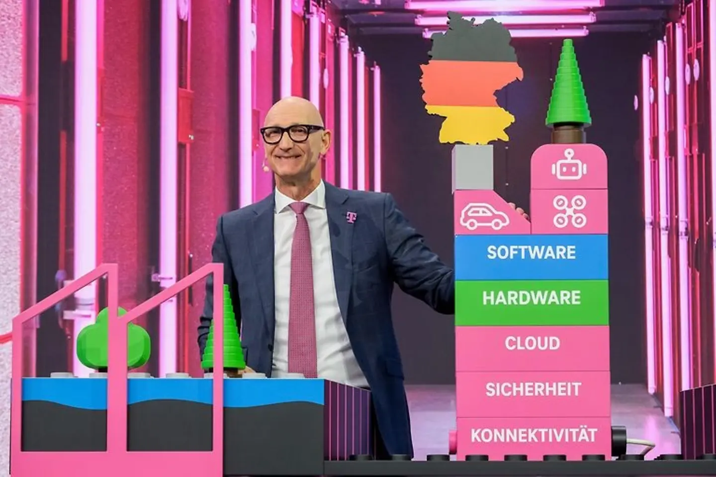 Tim Höttges presents a model of the AI factory in Munich on stage at the annual general meeting 2026