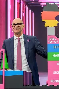 Tim Höttges presents a model of the AI factory in Munich on stage at the annual general meeting 2026