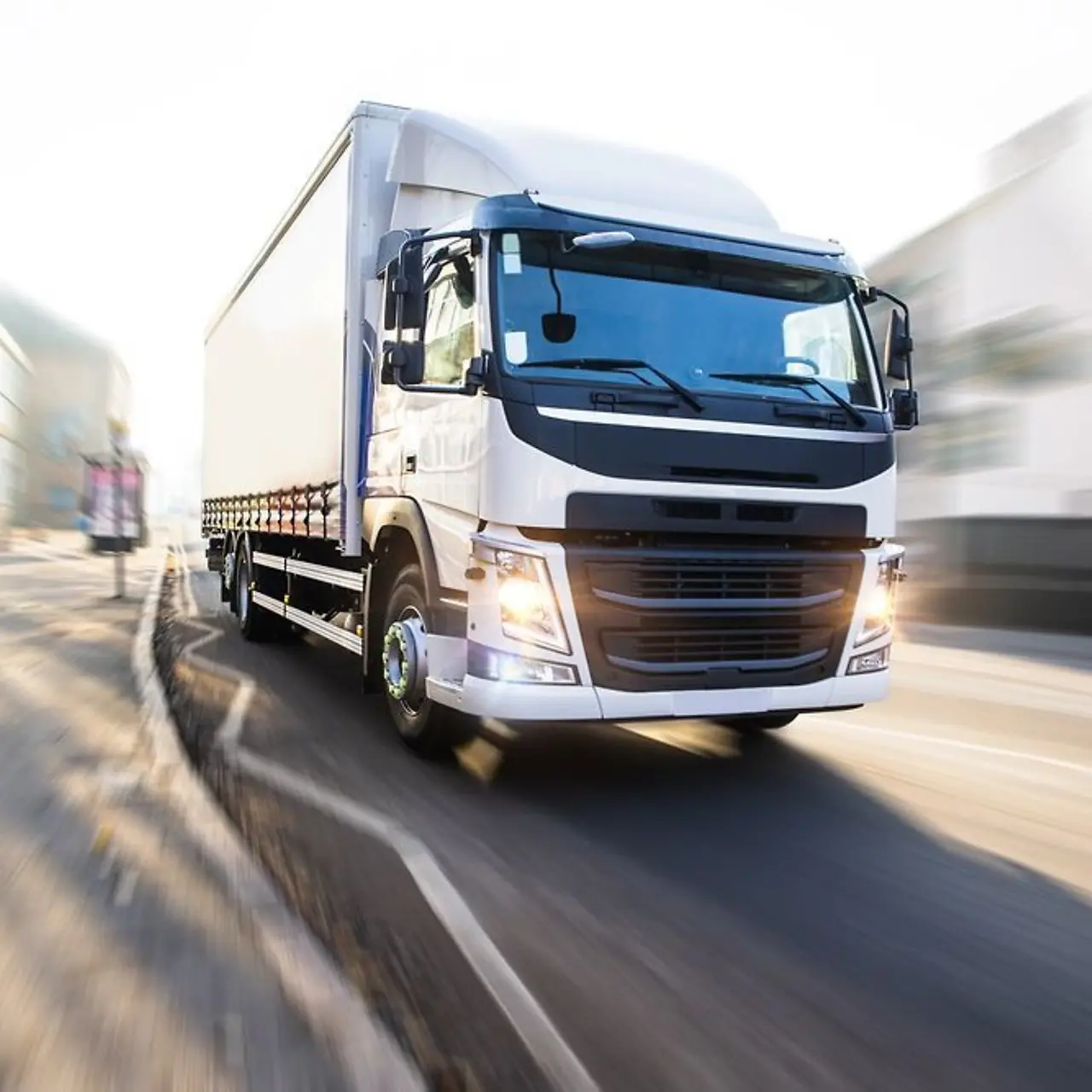 White truck crossing a town