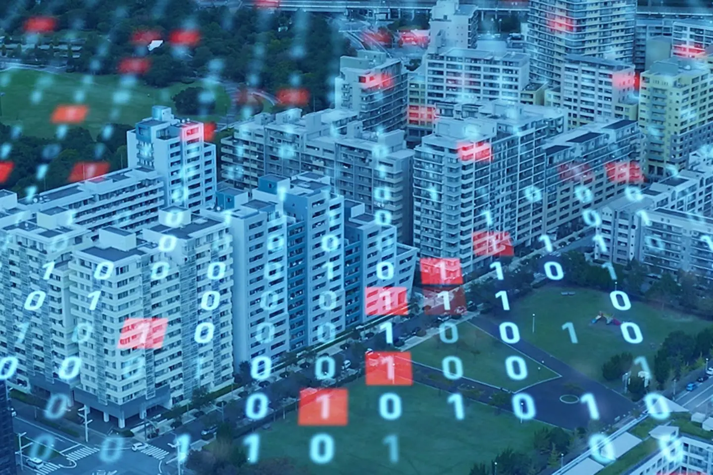 Vue aérienne d’un paysage de gratte-ciels survolé par des codes binaires.