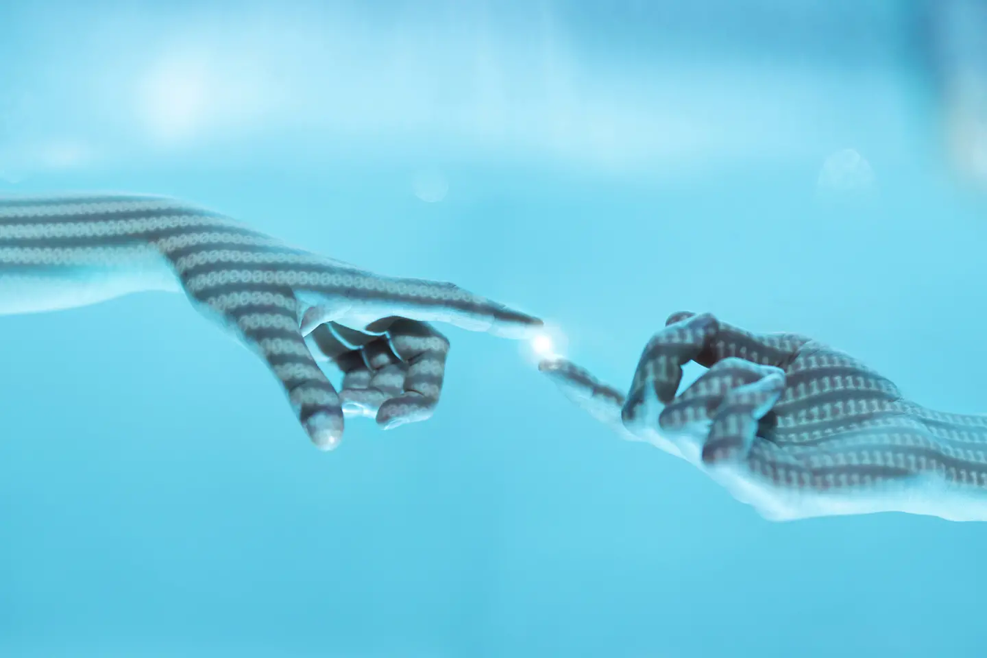 Two hands in a bluish light extend the fingertips, between which a light spot appears.