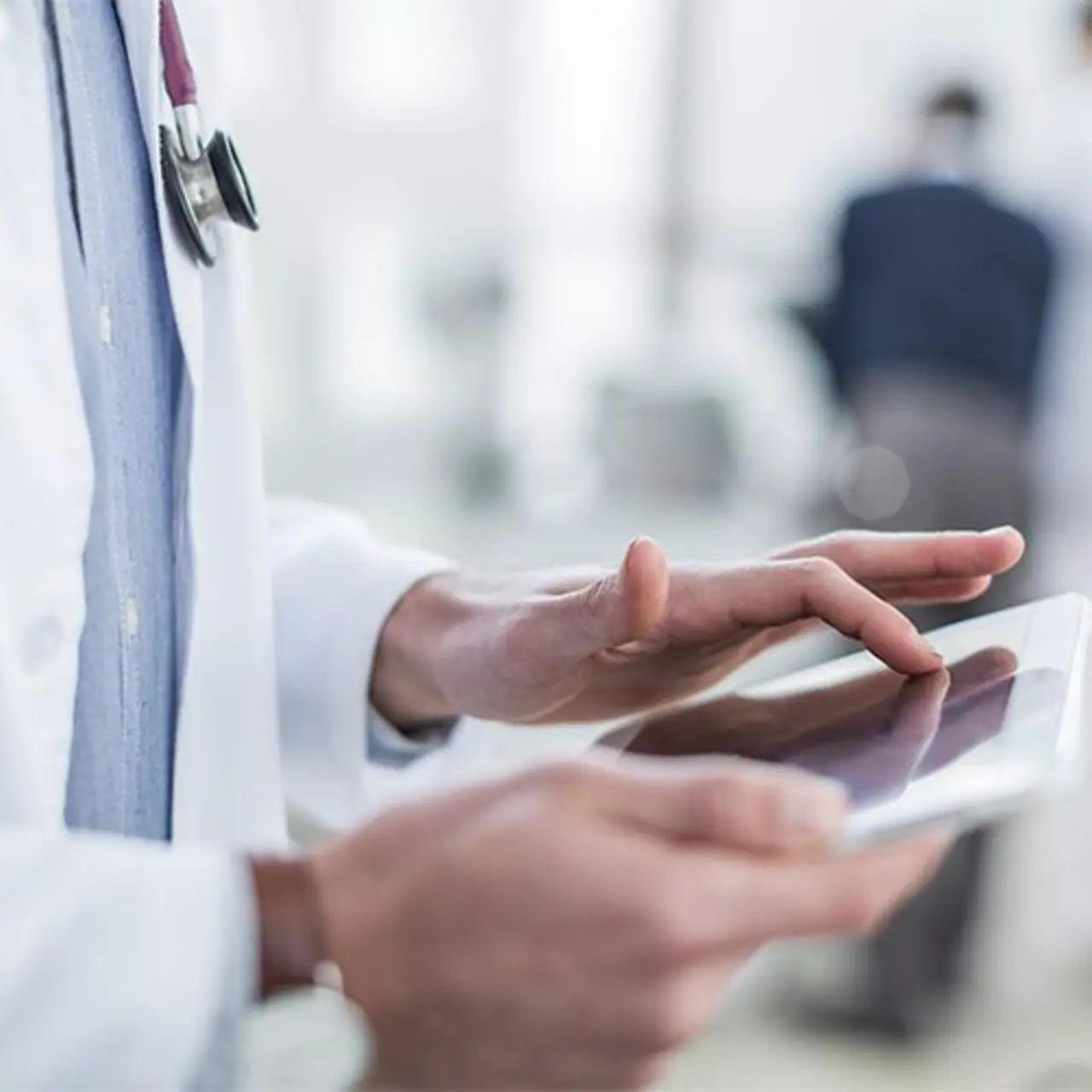 Doctor checks patient data via a tablet
